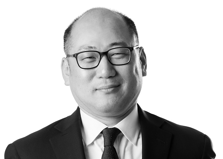 John Yoo, Investment Reporting Associate at Sage Financial Group. Headshot photograph of John Yoo smiling and looking directly at the camera, wearing professional attire.